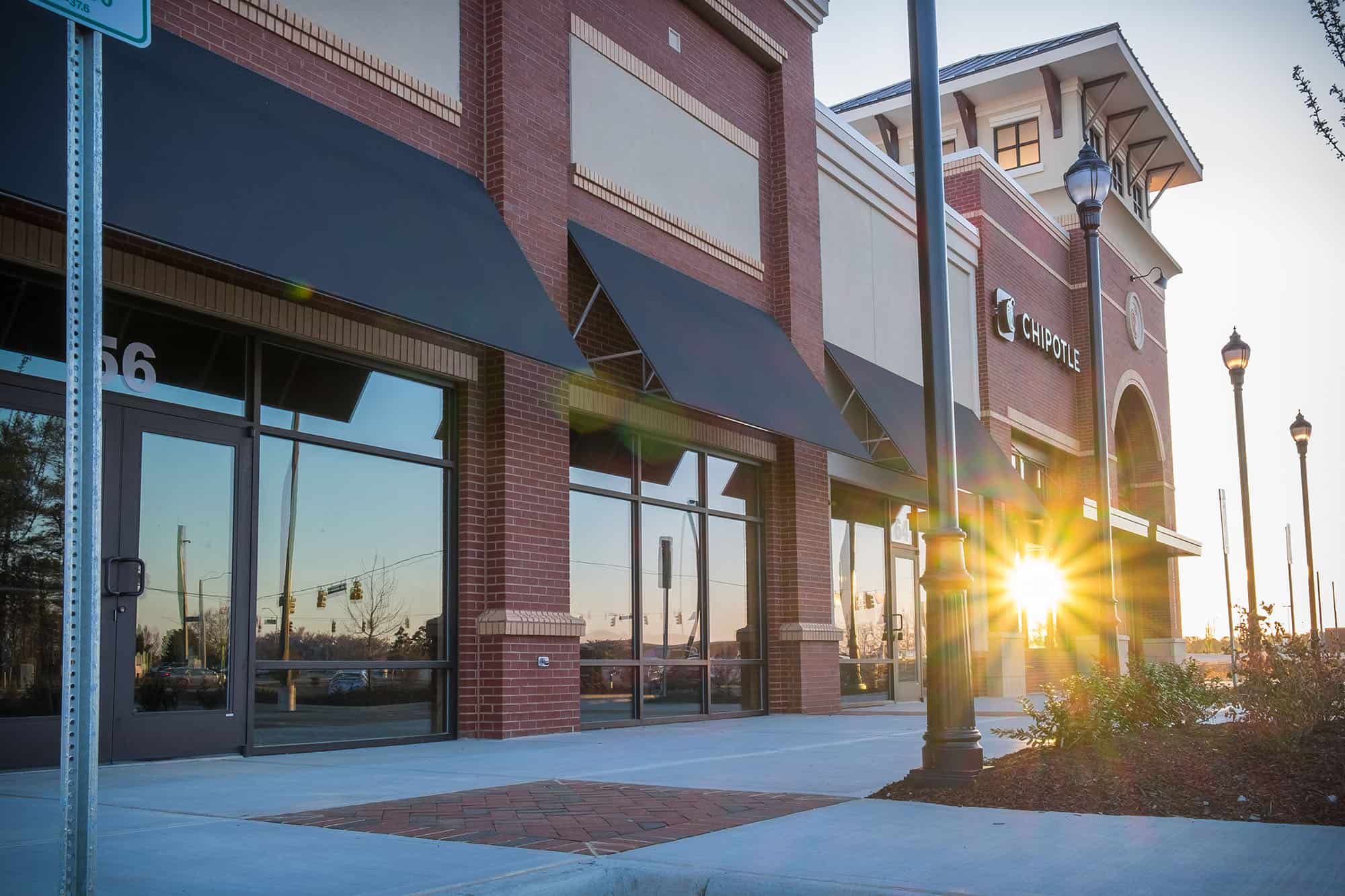 Side view of White Oak Shoppes by WIMCO in Garner, NC at sunrise.
