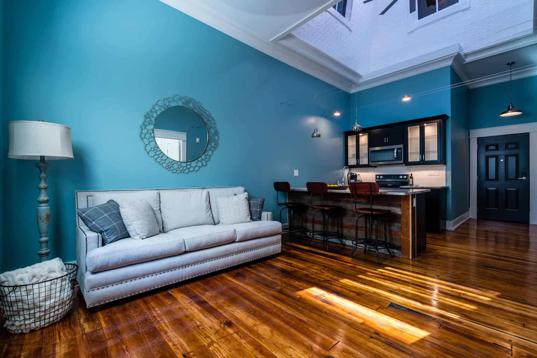 Wood floor, blue wall in center unit.